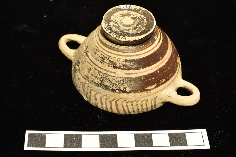 Miniature skyphos w handle zone decorated with pendant hooks on one side and vertical stripes on other, with alternating broad and narrow bands on body;   foot and interior totally coated.