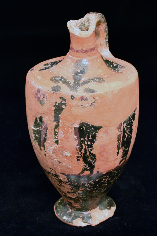 Lekythos w main zone opposite handle decorated w 3 figures draped in himatia, 2 facing 3rd;  int detail in incision & added red, red stripe below; lower body   solidly coated; shoulder decoration 3-petaled rosette with blob at base opposite handle, on either side heart-shaped ornament w dot below; red stripe at base of handle, handle, ext solidly coated.