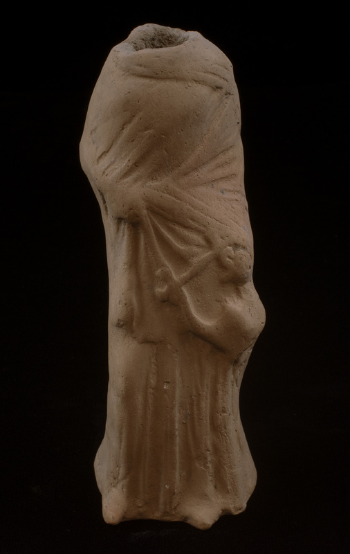 Mouldmade standing figure in chiton and himation, holding lyre in l hand.  R arm bent at elbow, hand holding drapery pulled across from l; lyre held diagonally in front of  l side of body.  Folds of chiton indicated by vertical ridges falling below himation.  Feet protrude at bottom.  Large vent hole at rear.