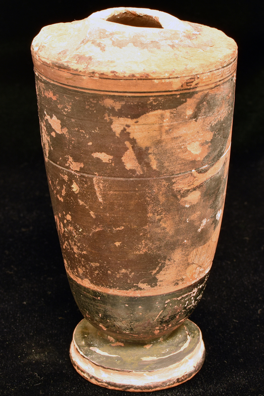 Fragmentary lekythos w main zone decorated with woman running right , looking left, with kalathos on ground before her with meander band above reserve stripe below: woman wearing chiton and himation and sakkos on head.  Lower body top of profile foot and exterior of base torus solidly coated.  Shoulder decoration probably radiating stripes but mostly worn off. stripes but mostly worn off.