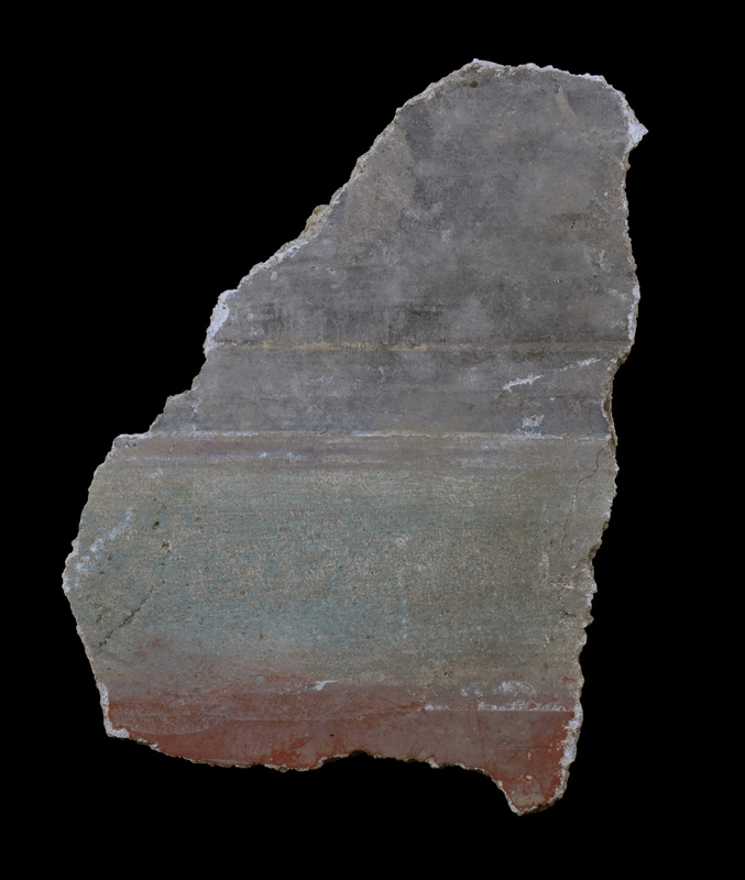 Fragment of medium thickness with broad green stripe dividing black & red panels. Black panel apparently framed w thin white stripe within which traces of curvilinear decoration in white; green stripe bordered by stripes: one red with narrow white bordering stripes, other apparently plain white.  Back fairly flat.