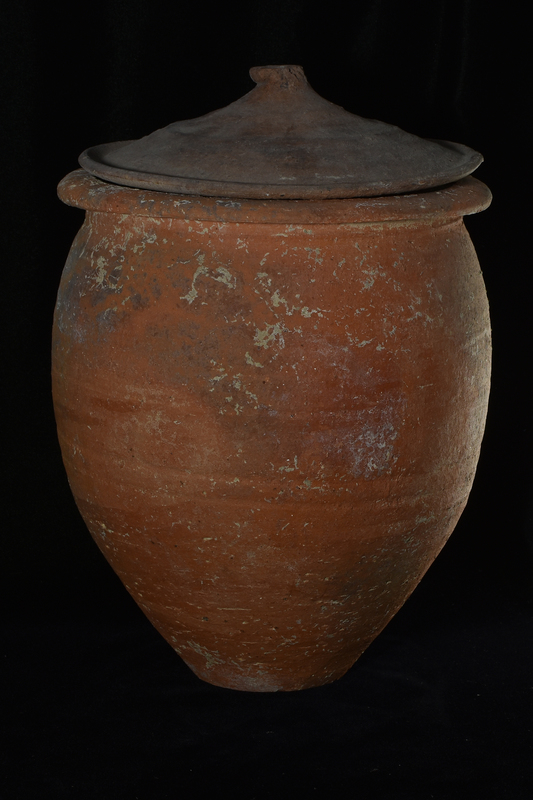 Large piniform jar with max D ca mid-height on flat base and outturned rim, of a type frequently used as a cremation burial urn.  Particularly prominent wheel marks on interior, more irregular on exterior which presumably smoothed.