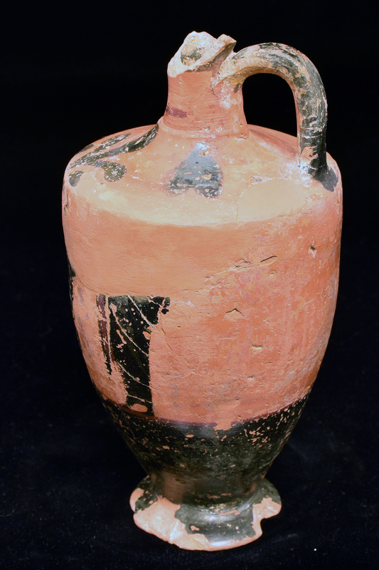 Lekythos w main zone opposite handle decorated w 3 figures draped in himatia, 2 facing 3rd;  int detail in incision & added red, red stripe below; lower body   solidly coated; shoulder decoration 3-petaled rosette with blob at base opposite handle, on either side heart-shaped ornament w dot below; red stripe at base of handle, handle, ext solidly coated.