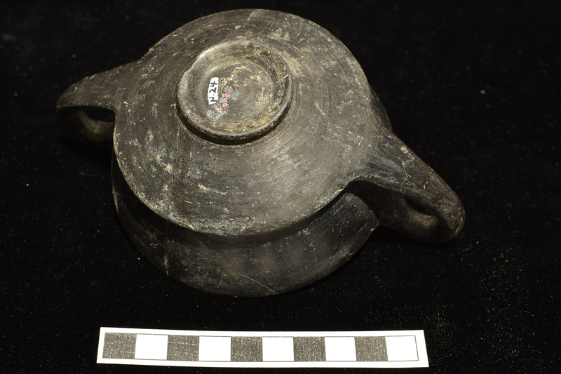 Kantharos with prominent angular carination at juncture of bowl & rim on low raised base.  Burnished inside and out.