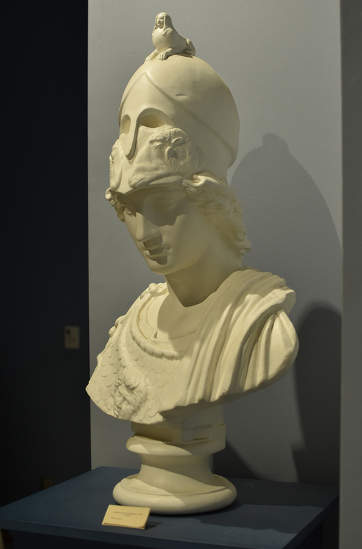 The helmeted Athena is a replica of a Roman copy of the so-called Giustiniani type of the 5th c. BC. The cast in the Wilcox Collection represents only the bust of a large statue in the Vatican Museums, Rome. The original sculpture was found in Rome on the Esquiline Hill in the 17th c. and belonged to the collection of Vincenzo Giustiniani in the Palazzo Giustiniani.
