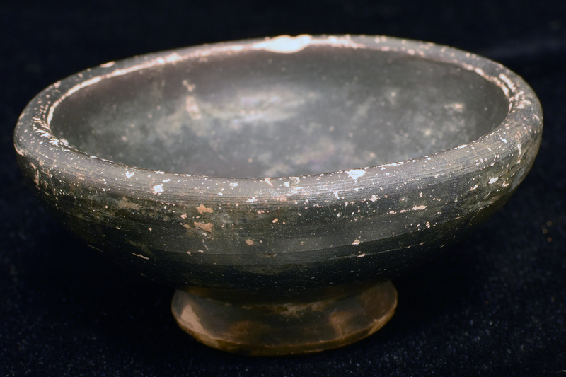 Convex-sided bowl w max D just below thick rim, ring base.  Coated all over, except for underside of base w dark paint.