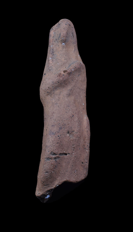 Mouldmade standing figure w palla draped over head and falling on either side, pulled across body diagonally over r arm; l arm at side holding vertical clump of drapery; slightly projecting right knee.  Pinched ridge of clay articulating face.  2 large vent holes in back.