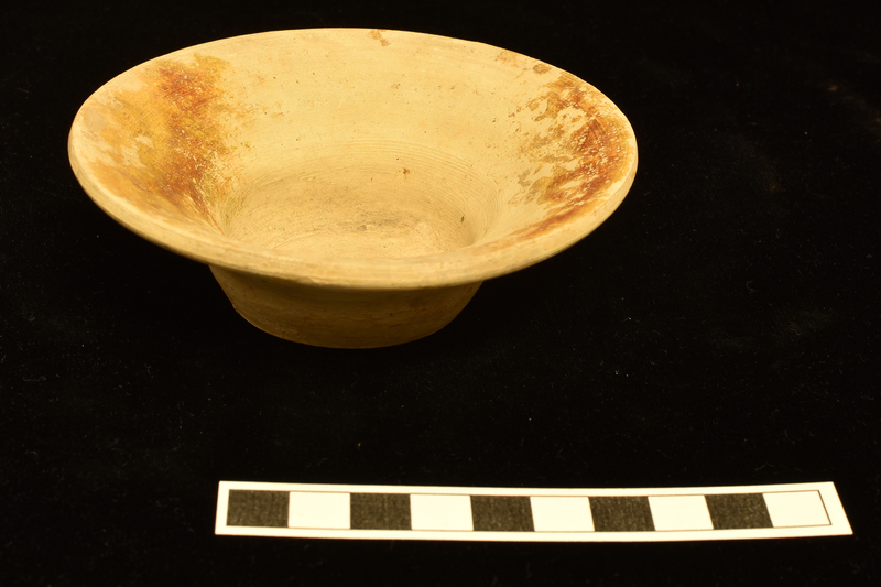 Wide-rimmed bowl w prominent wheel marks; flat base.  Slip or stain on opposite sides of int rim.